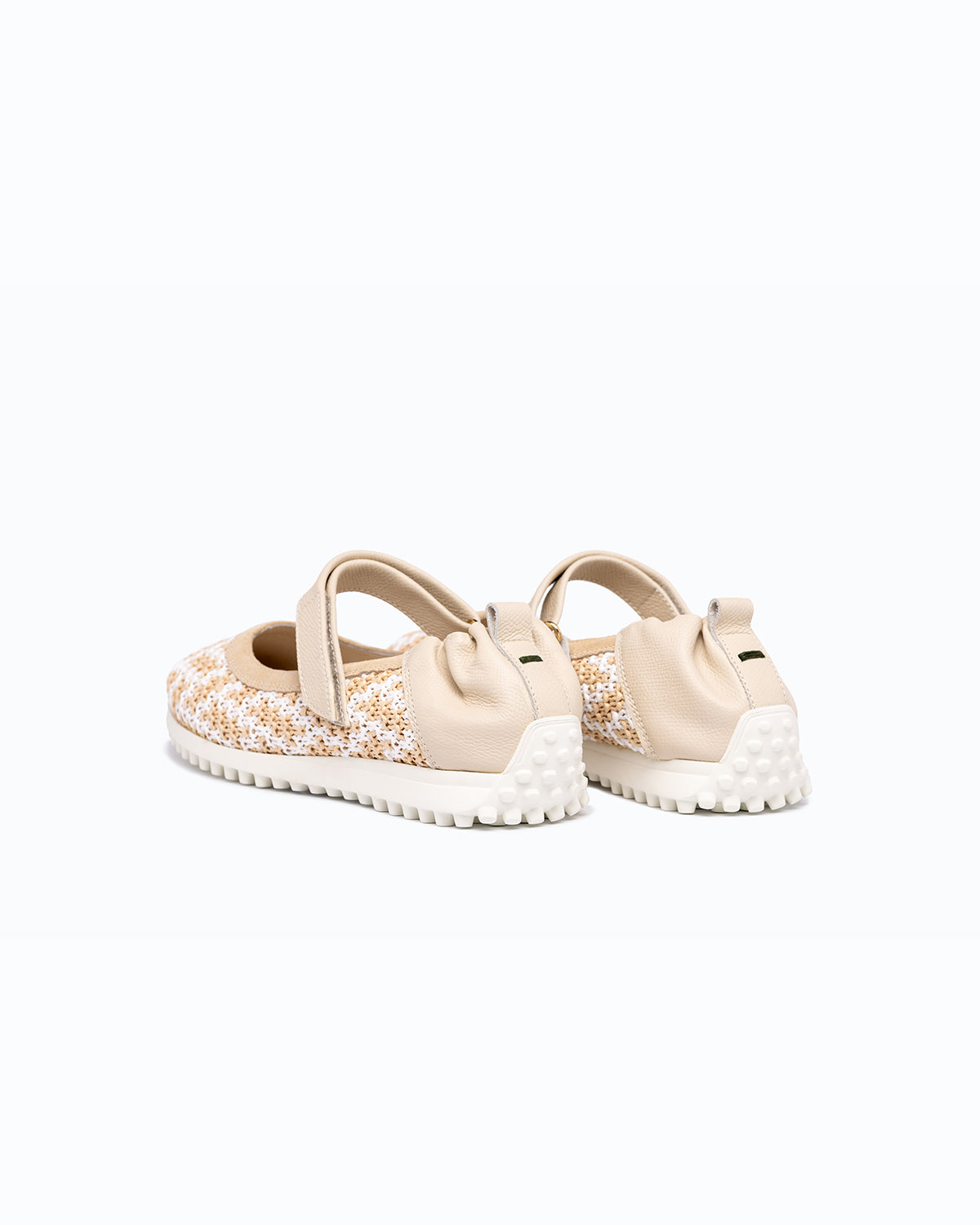 Beige, white velour and woven fabric DLS ballet flats, shown in a studio still life.