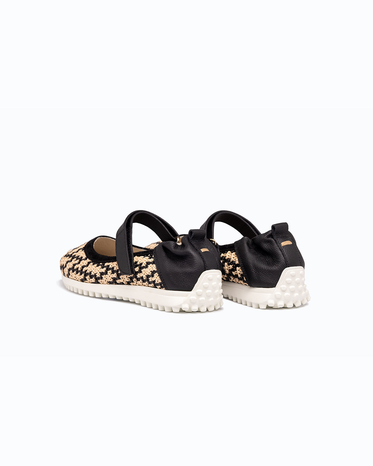 Black, beige velour and woven fabric DLS ballet flats, shown in a studio still life.