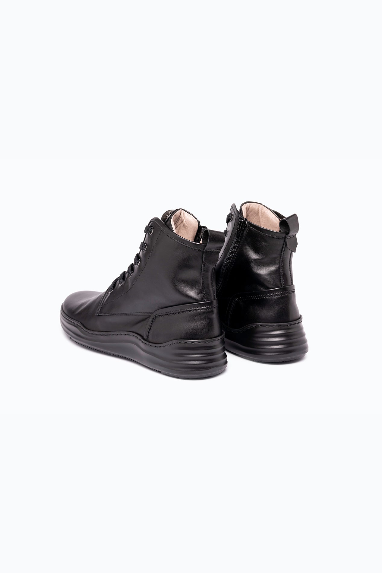 Black nappa leather DLS boots, shown in a studio still life.