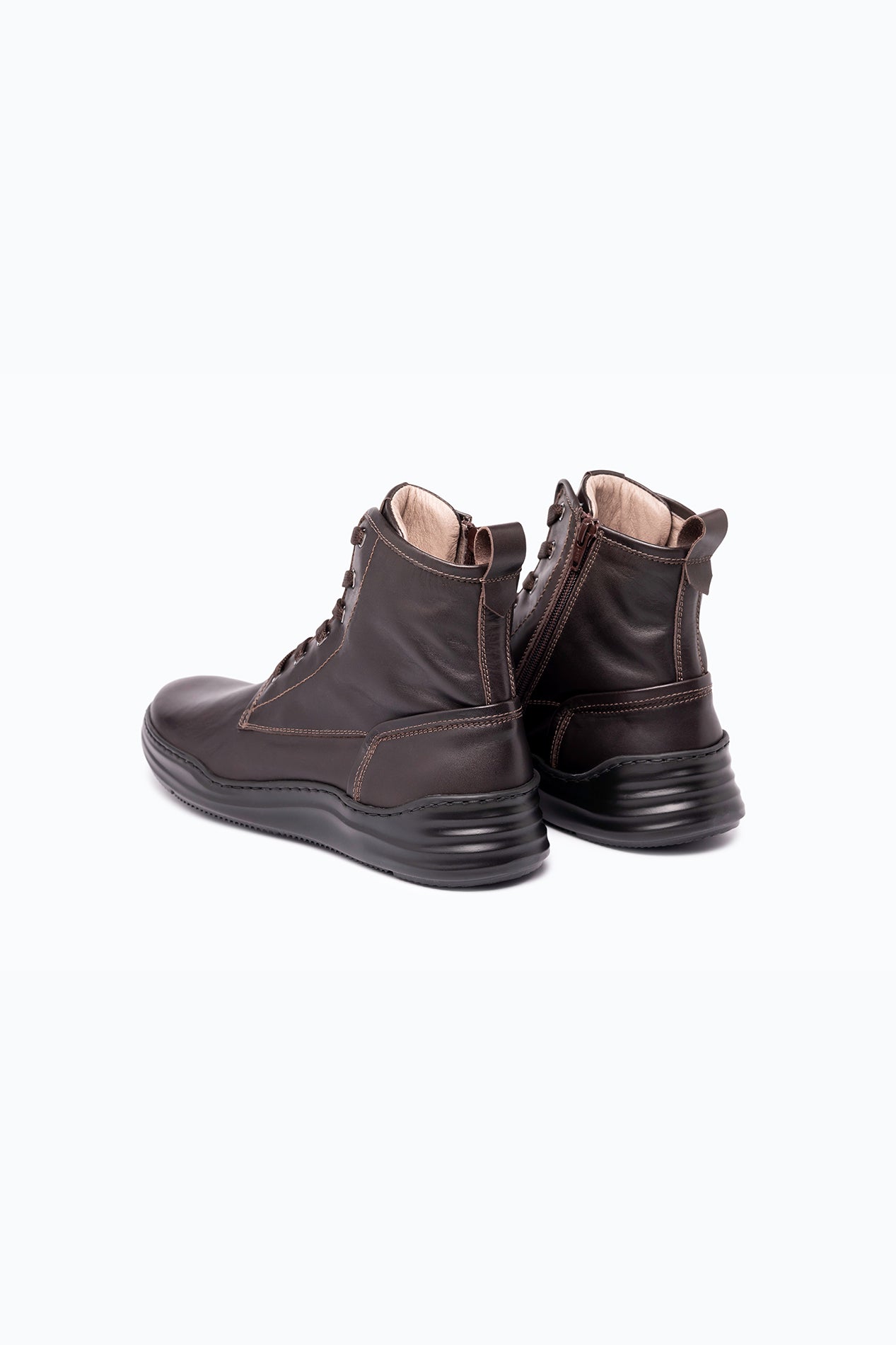 Brown nappa leather DLS boots, shown in a studio still life.