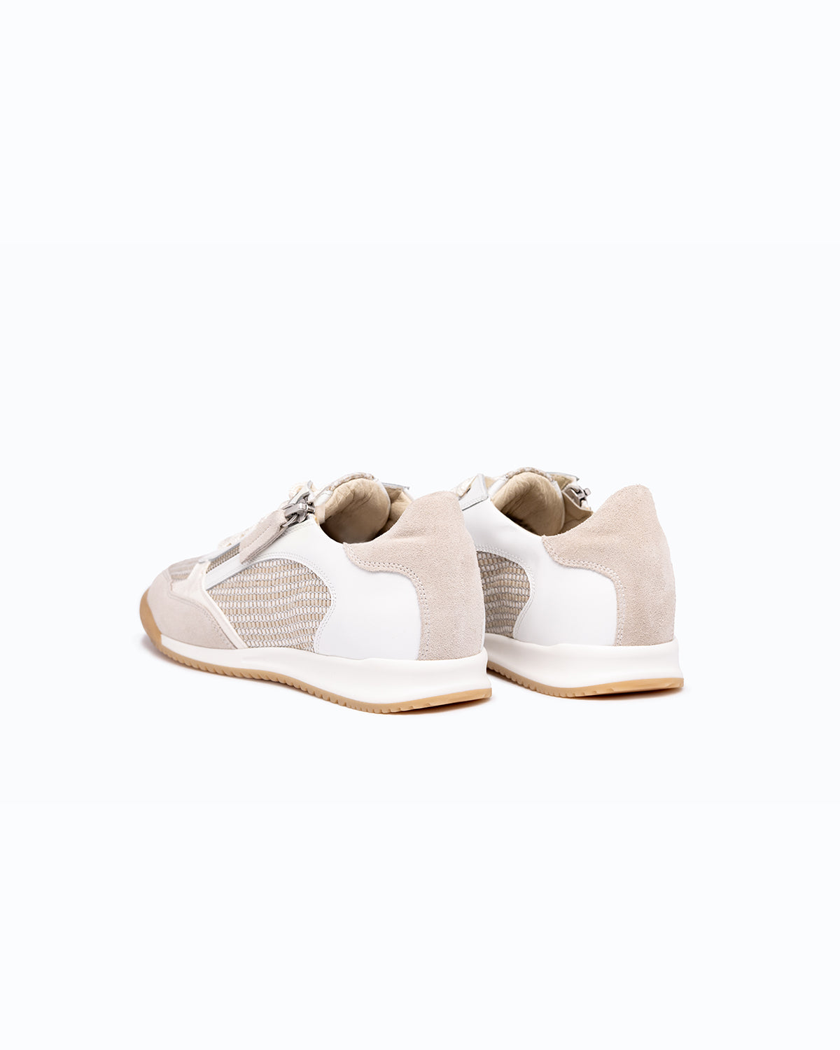 White, off-white nubuck and leather DLS sneakers, shown in a studio still life.