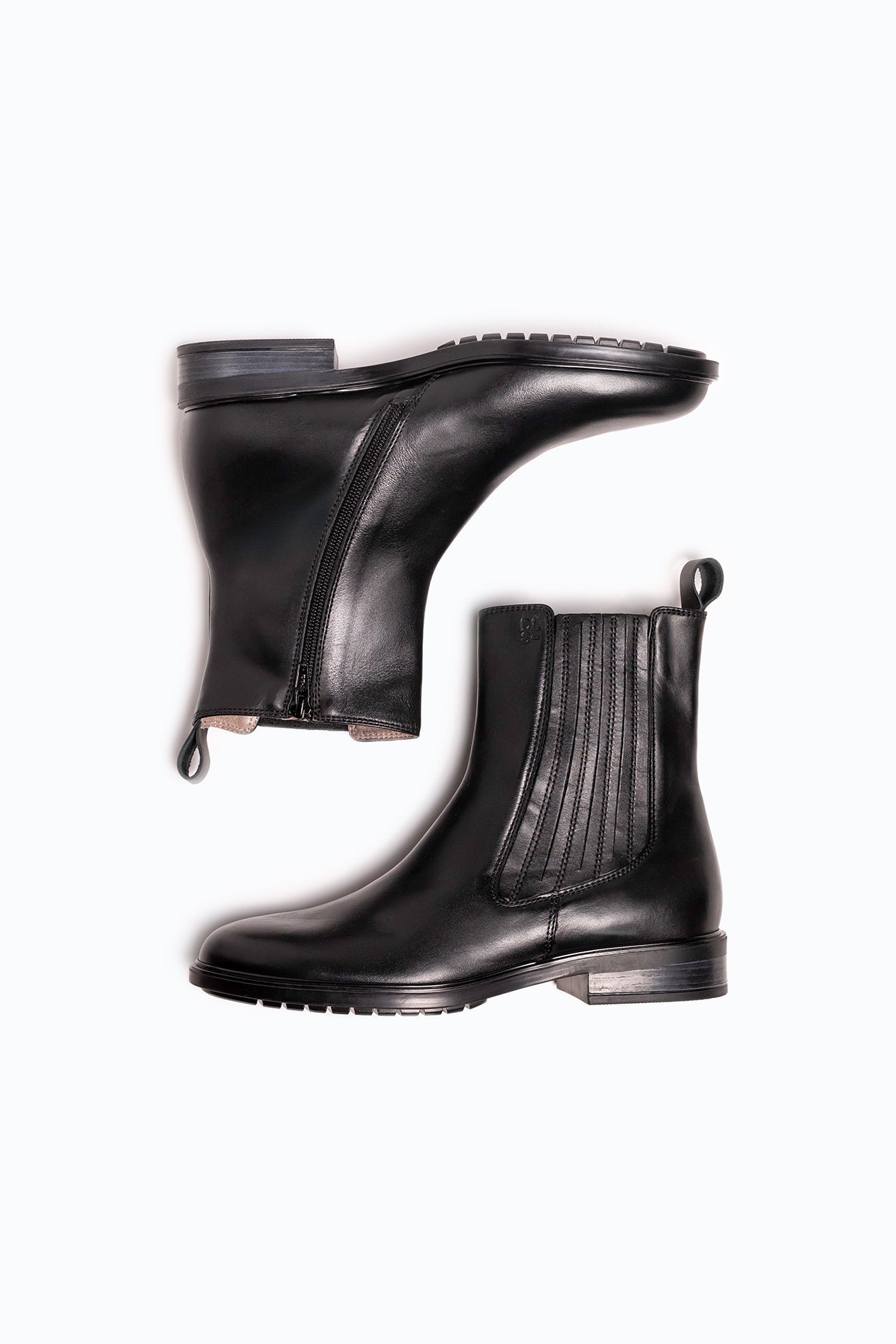 Black DLS ankle boots, shown in a studio still life.