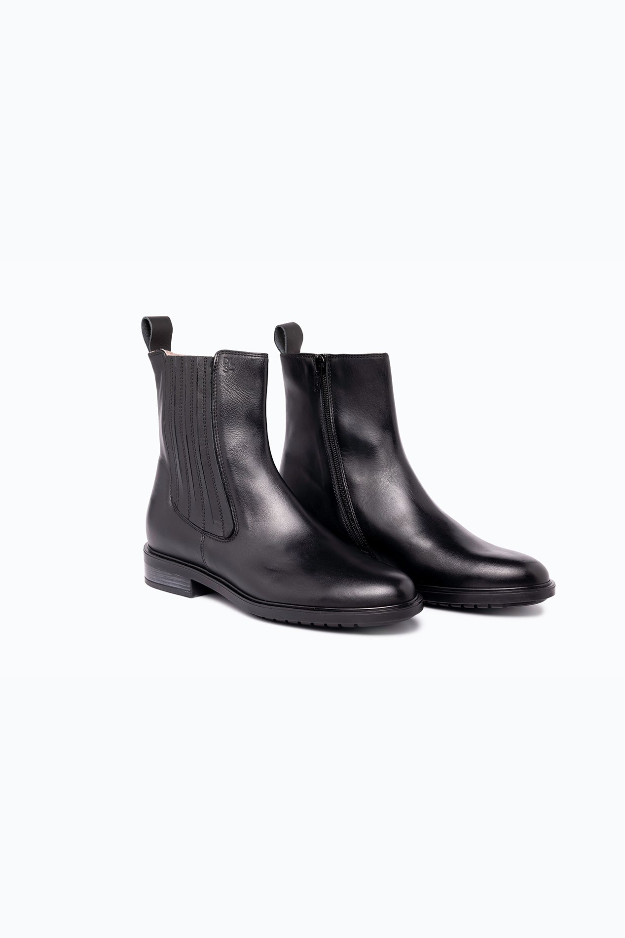 Black DLS ankle boots, shown in a studio still life.