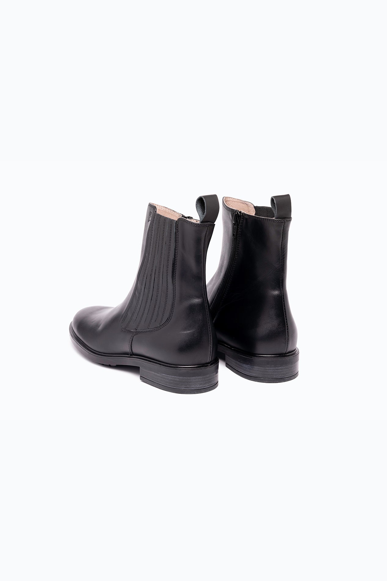 Black DLS ankle boots, shown in a studio still life.