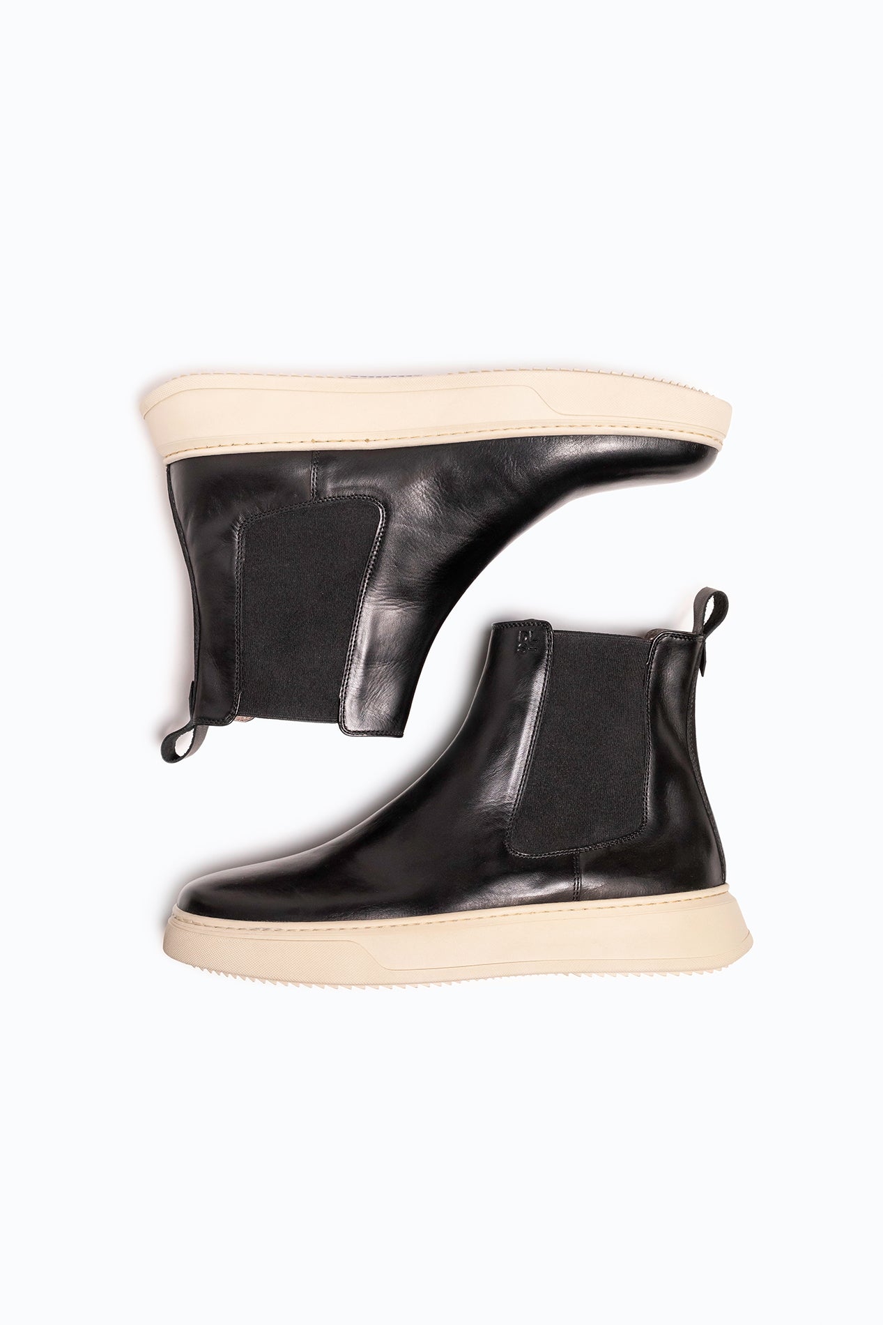 Black velour and leather DLS boots, shown in a studio still life.
