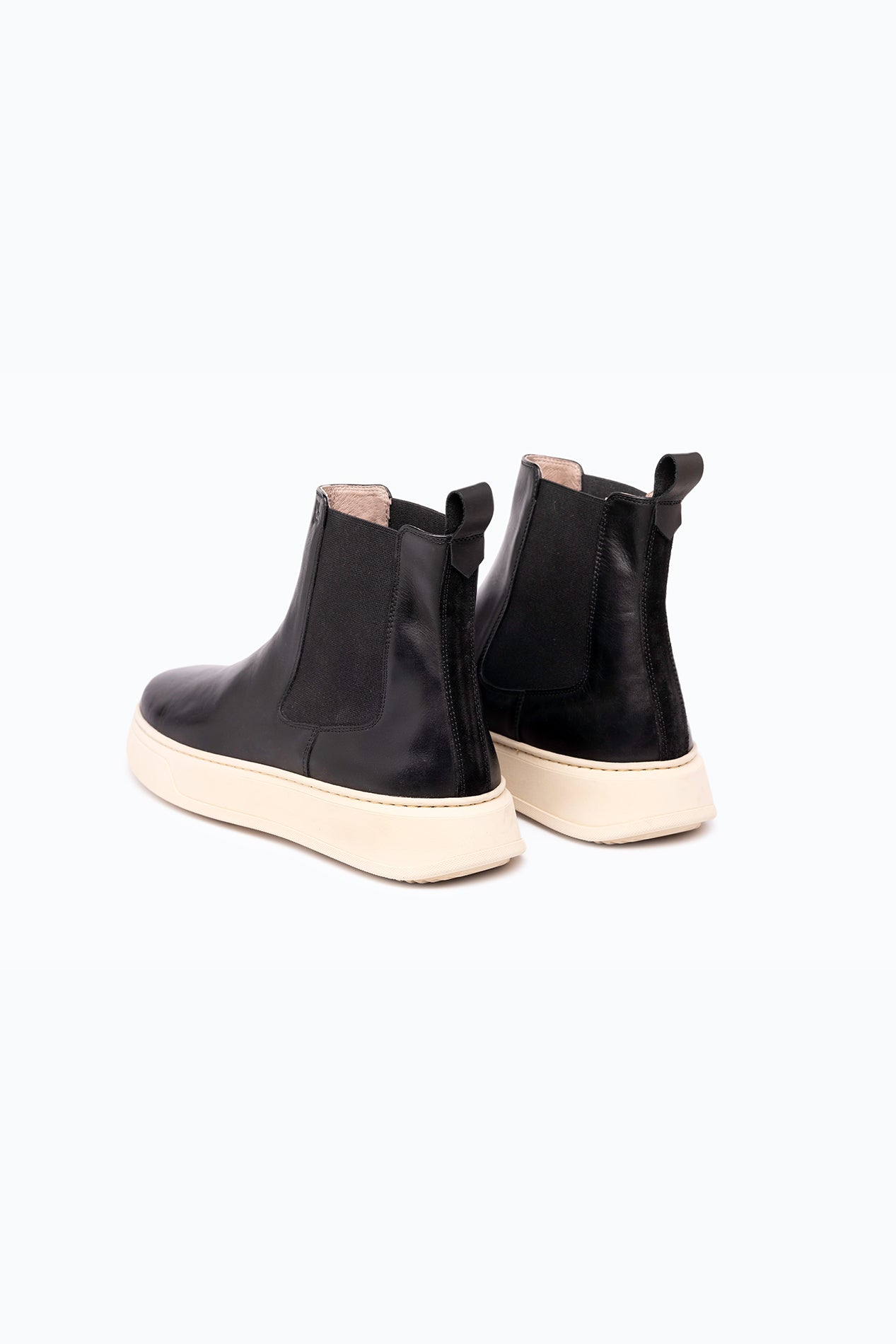 Black velour and leather DLS boots, shown in a studio still life.