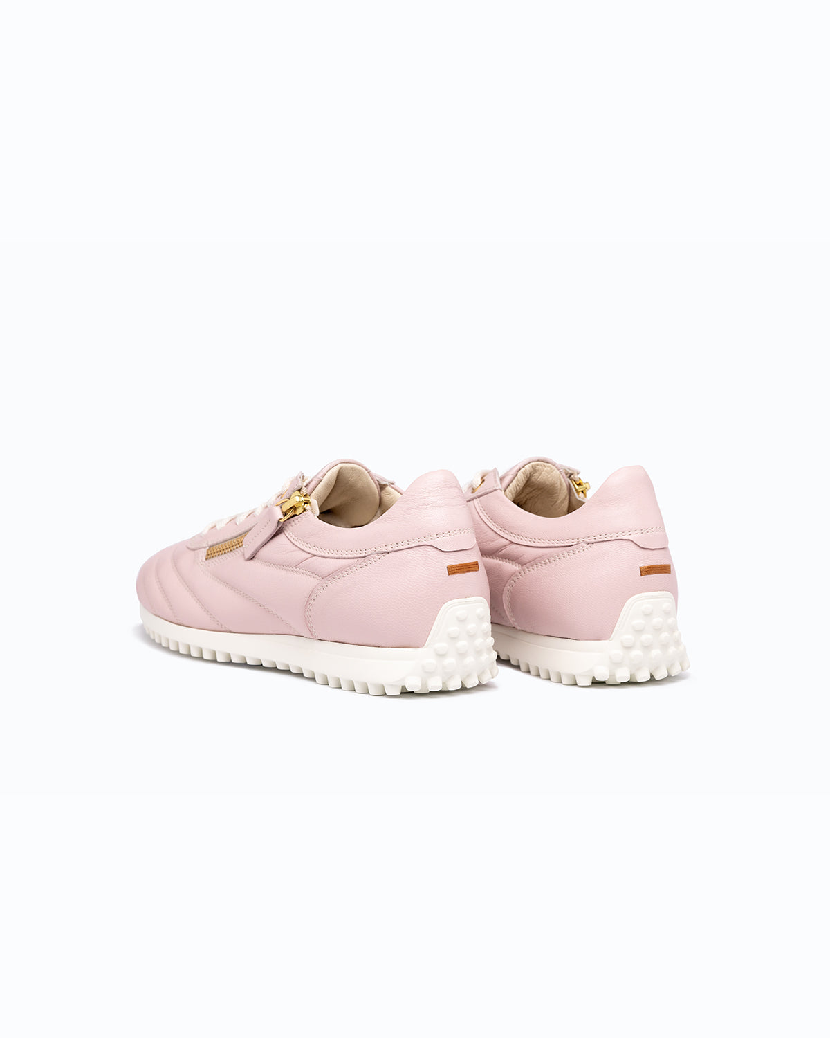 Pink DLS sneakers, shown in a studio still life.