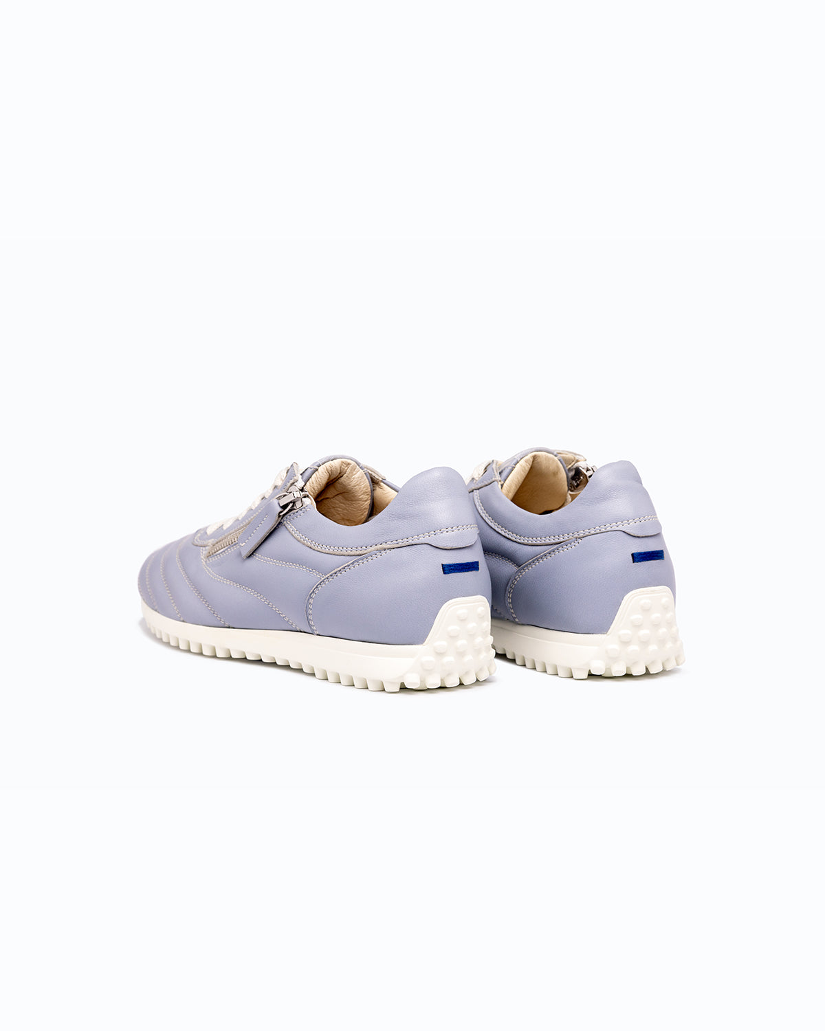 Sky blue DLS sneakers, shown in a studio still life.