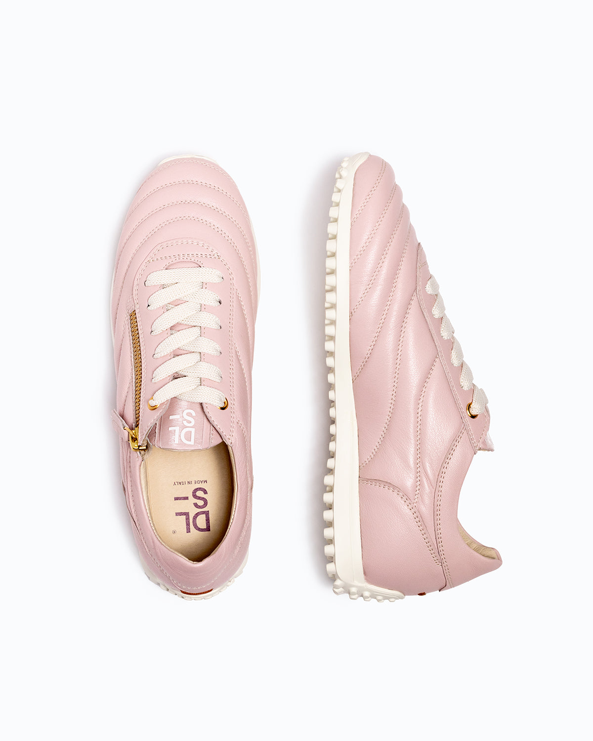 Pink DLS sneakers, shown in a studio still life.