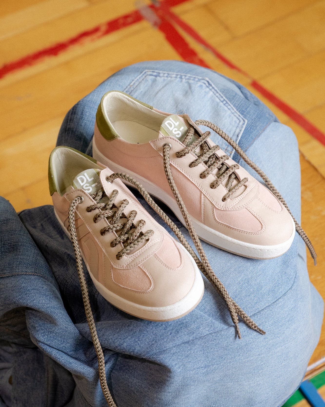 Blush pink, sage green velour and nubuck Re-Novo trainers, captured in an indoor lifestyle scene.