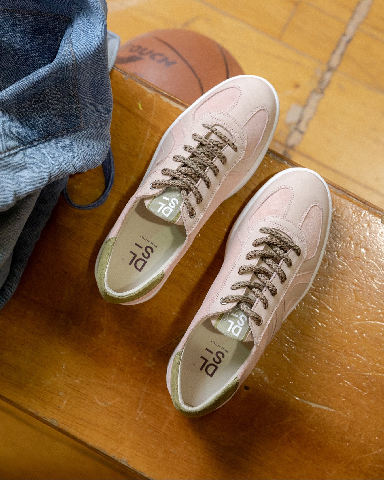 Rose, olive green velour and nubuck Re-Novo fashion sneakers, worn in a lifestyle editorial shot.