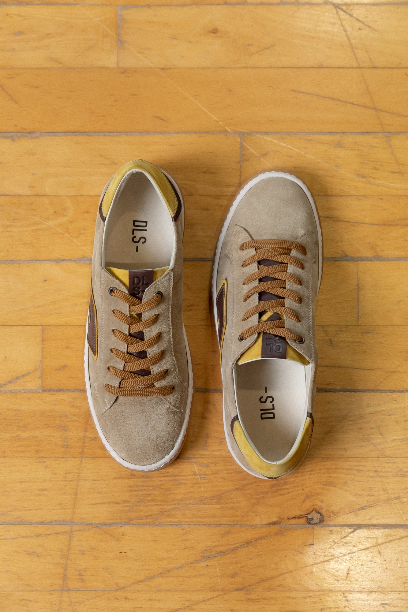 Golden, ecru, caramel velour and nubuck Re-Novo fashion sneakers, worn in a lifestyle editorial shot.