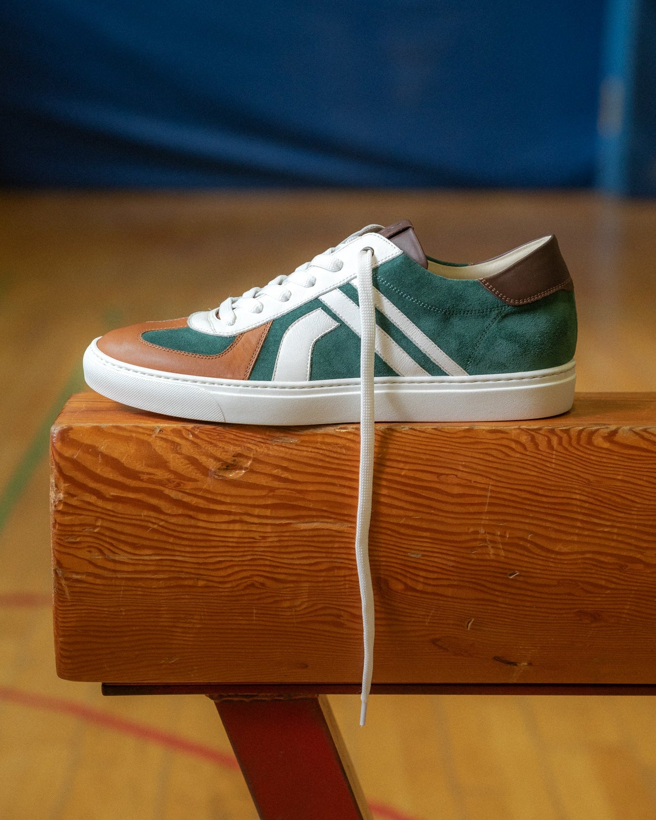 Green, brown velour and leather Re-Novo fashion sneakers, presented in an on-location lifestyle image.