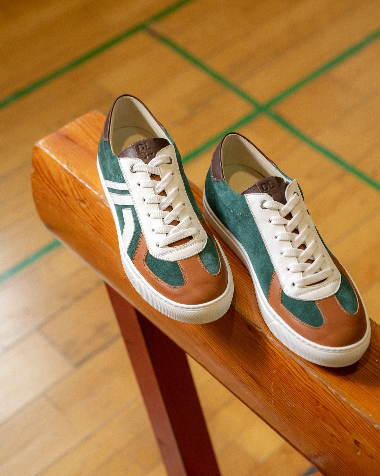 Sage green, caramel velour and leather Re-Novo leather sneakers, photographed on location in a lifestyle scene.