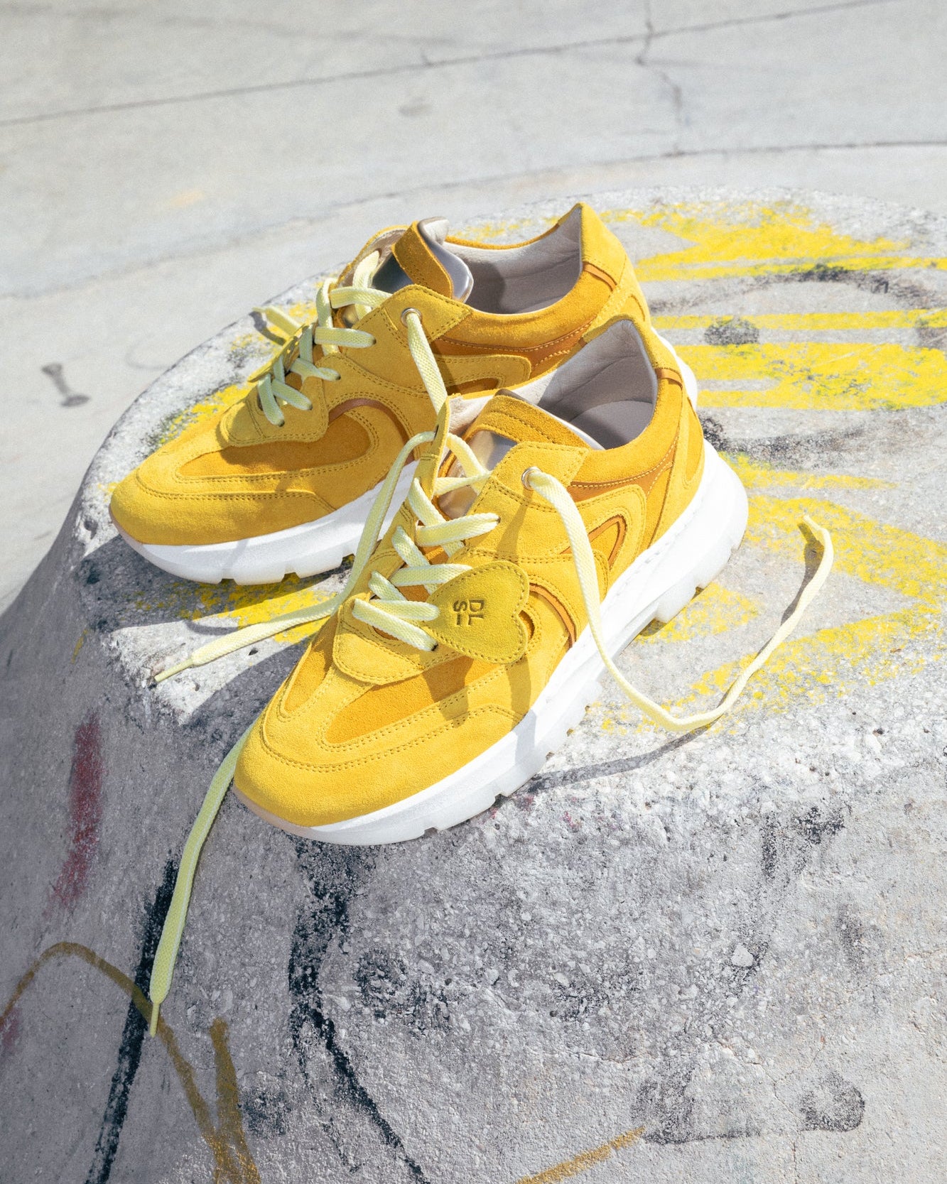 Amber velour Re-Novo trainers, depicted in a casual editorial context.