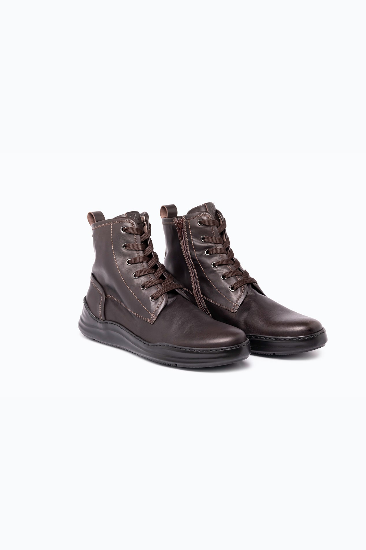 Brown nappa leather DLS boots, shown in a studio still life.
