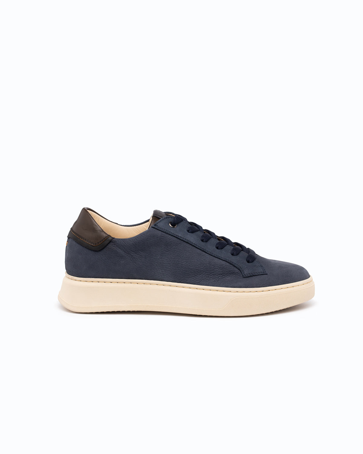 Blue shoe with cream bottom and black lace on white background, shown sideways