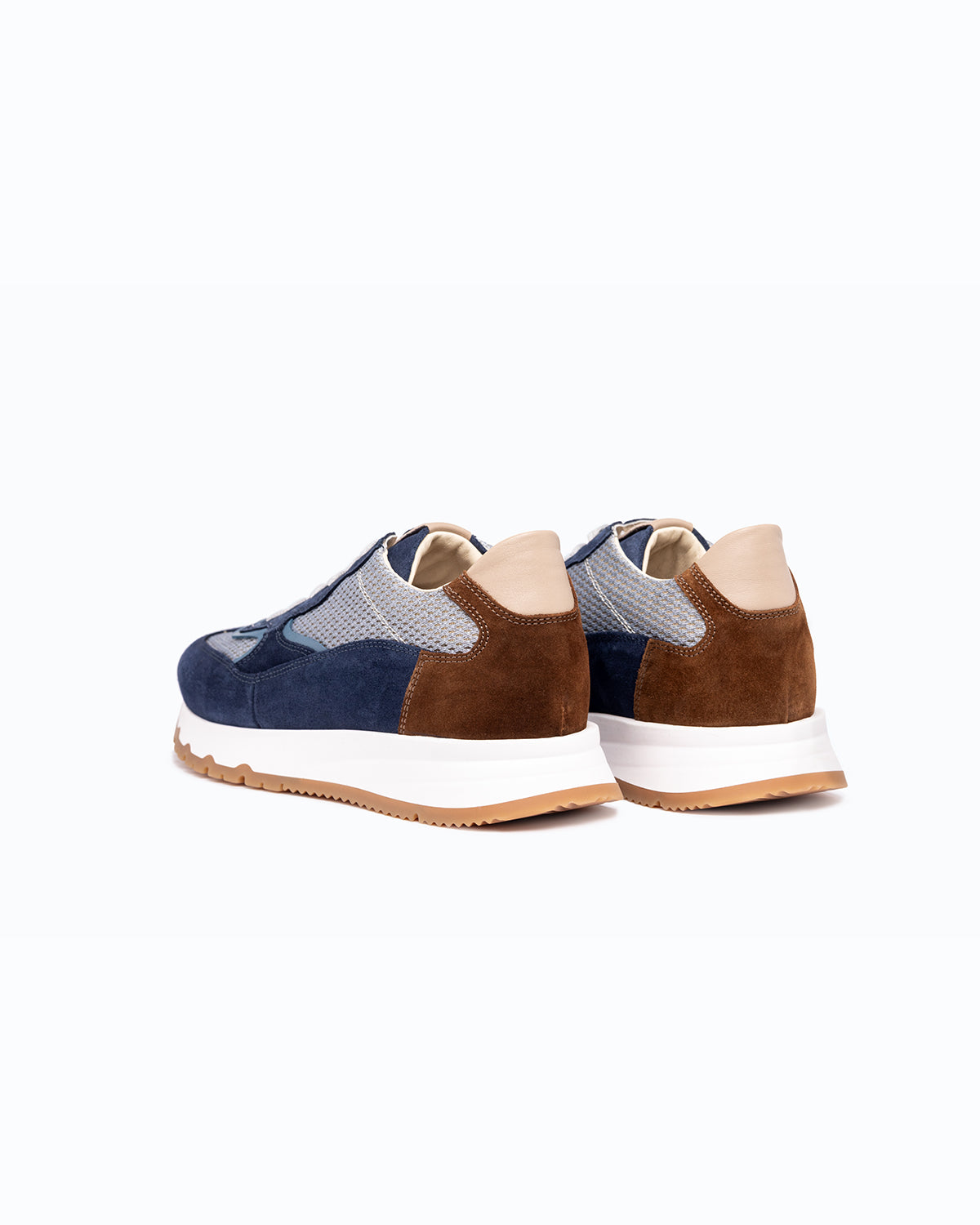 Navy, brown, grey velour DLS sneakers, shown in a studio still life.