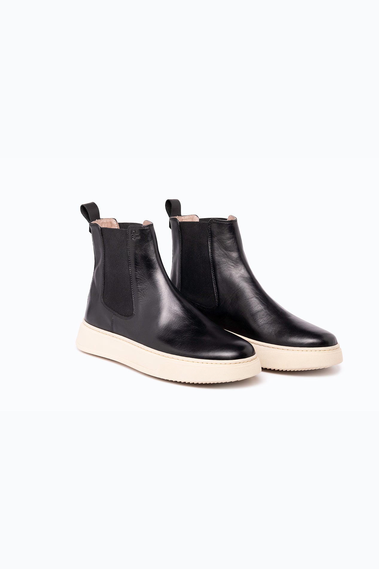 Black velour and leather DLS boots, shown in a studio still life.