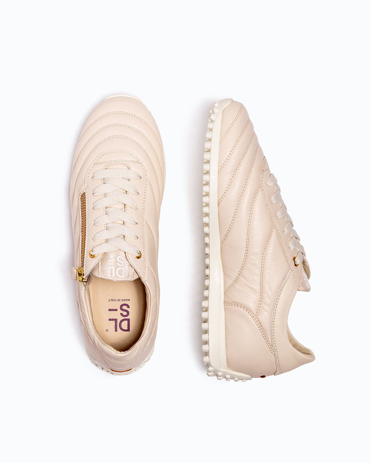 Off-white DLS sneakers, shown in a studio still life.
