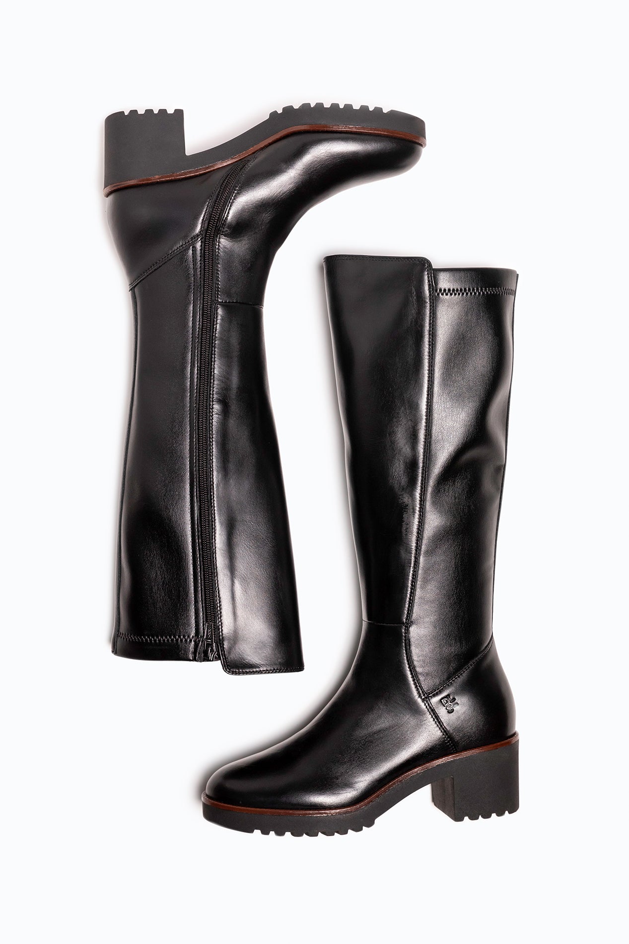 Black, brown DLS heeled boots, shown in a studio still life.