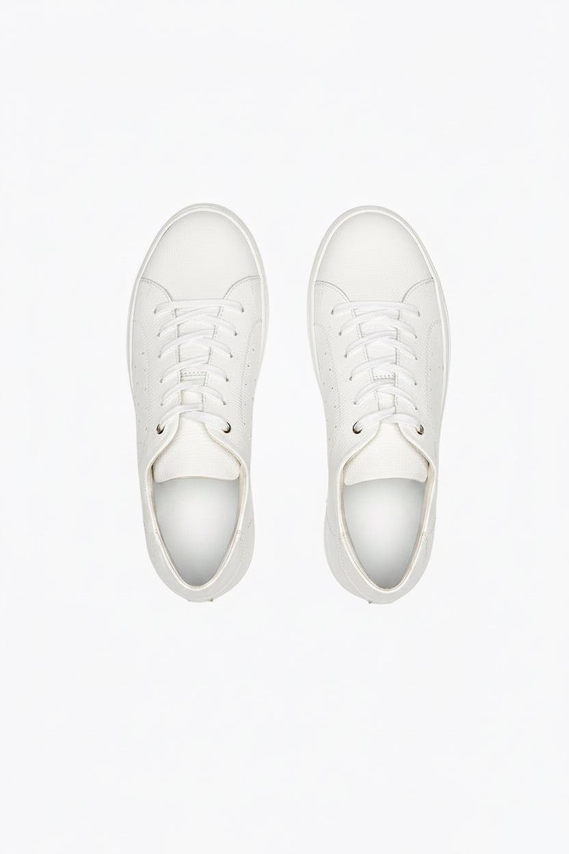 White DLS sneakers, shown in a studio still life.