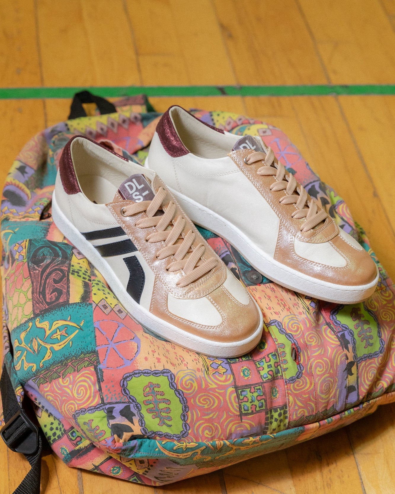 Blush pink, sage green velour and nubuck Re-Novo trainers, captured in an outdoor lifestyle scene.