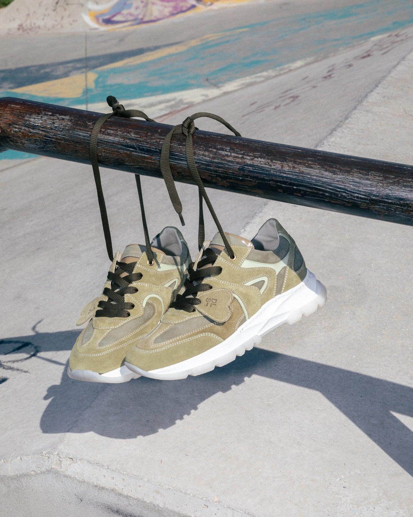 Dove grey, khaki velour Re-Novo leather sneakers, featured in a styled outdoor setting.