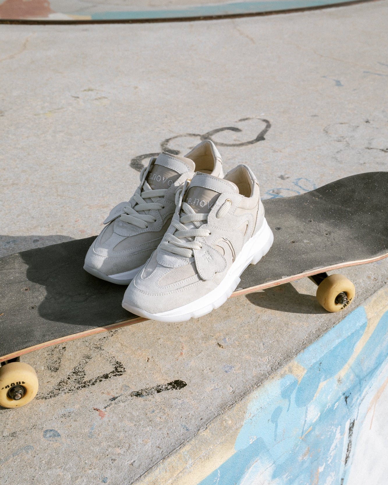 Sand, off-white velour Re-Novo fashion sneakers, presented in an on-location lifestyle image.