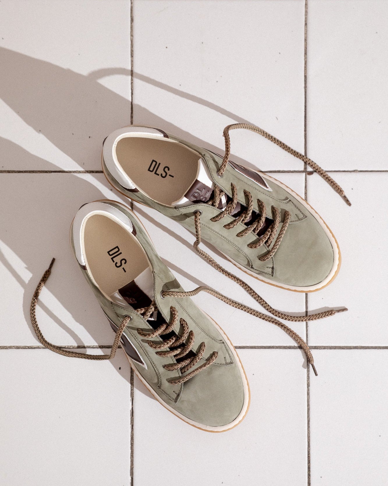 Army green, sage green, white nubuck and leather Re-Novo sneakers, photographed in a lifestyle setting.