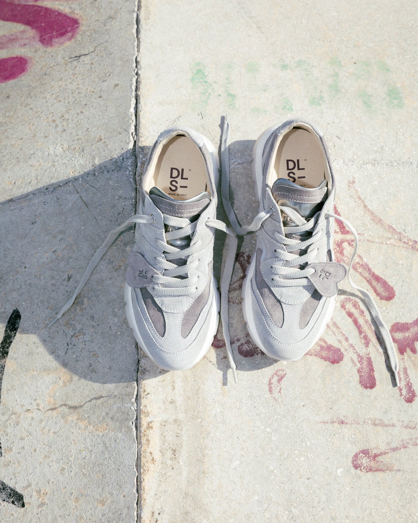 Grey velour Re-Novo sneakers, photographed in a lifestyle setting.