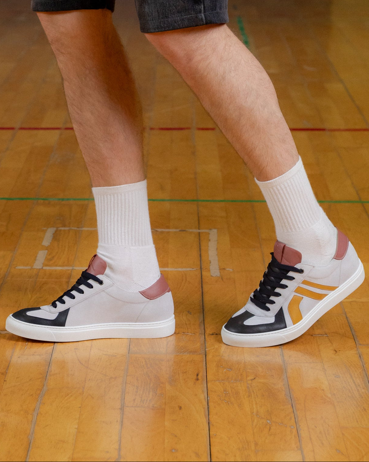Stone, off-white, cobalt velour and leather Re-Novo leather sneakers, photographed on location in a lifestyle scene.